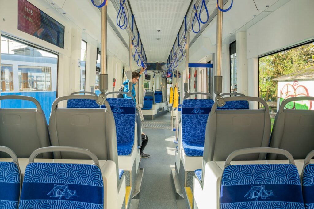 Interior view of an empty tram in Wrocław, Poland, with modern seating and design.